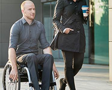 Man in wheelchair talking to colleague | CNA Insurance