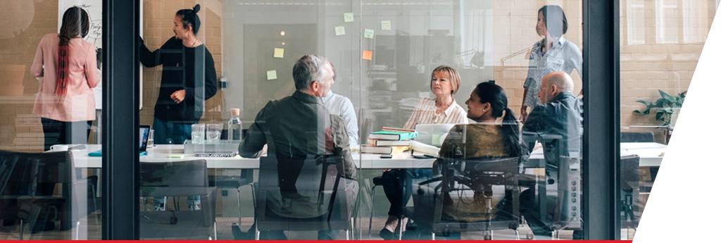 Professionals conducting analysis at conference room table l CNA Insurance