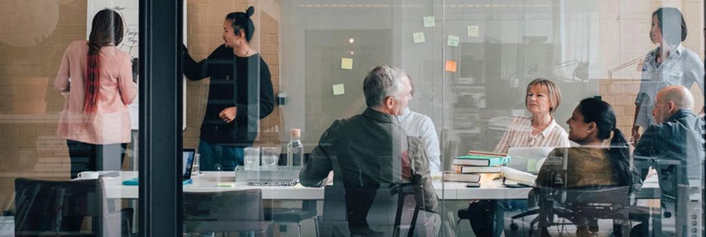 Business professionals brainstorming in conference room | CNA Insurance