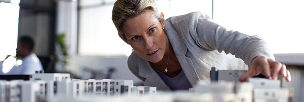 Female architect engineer examining model in office | CNA Insurance