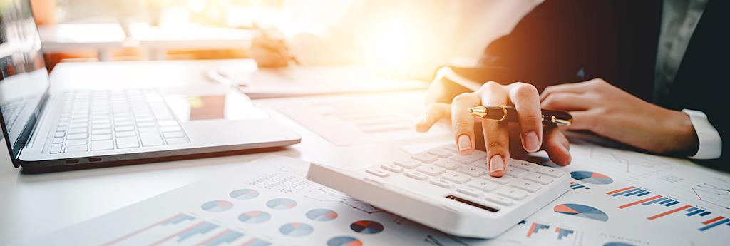 Accountant analyzing data on desk in office | CNA Insurance