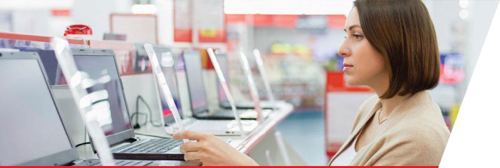 Woman browsing laptops in store | CNA Insurance