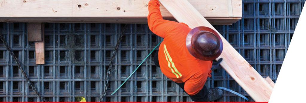 Construction worker holding wooden beams | CNA Insurance