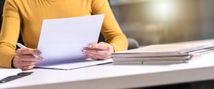 Female taking notes at table | CNA Insurance