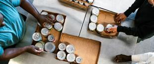 Volunteers preparing donation boxes at food bank| CNA Insurance