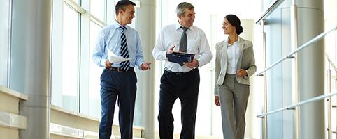 Group of coworkers walking down hall | CNA Insurance