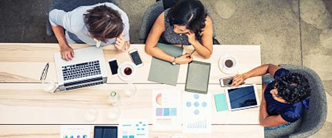 Aerial view of group working at table | CNA Insurance