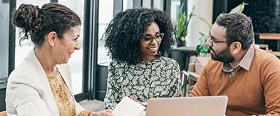 Diverse group looking over computer | CNA Insurance