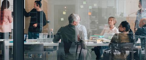 Professionals conducting analysis at conference room table l CNA Insurance