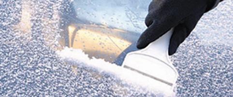 Man scraping ice off car windshield | CNA Insurance