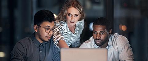 3 people working around a computer